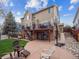 Backyard with patio area, outdoor seating, lush lawn and a basketball hoop at 8766 Cresthill Ln, Highlands Ranch, CO 80130