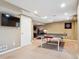 Basement features a ping pong table, entertainment area, and recessed lighting for a great recreational space at 8766 Cresthill Ln, Highlands Ranch, CO 80130