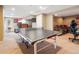 Finished basement featuring a ping pong table, wet bar, and entertainment area for ultimate relaxation and entertainment at 8766 Cresthill Ln, Highlands Ranch, CO 80130