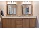 Bathroom with double sinks, granite counters, and wooden cabinets offers plenty of space at 8766 Cresthill Ln, Highlands Ranch, CO 80130
