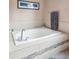 Elegant bathtub with a tile surround, chrome fixtures, and decorative accents creates a luxurious bathing experience at 8766 Cresthill Ln, Highlands Ranch, CO 80130
