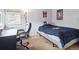 Bedroom boasting natural light with comfortable bed and functional desk setup ideal for rest and study at 8766 Cresthill Ln, Highlands Ranch, CO 80130