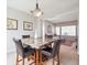 Dining area featuring a marble table with four chairs, and an open view into the bright living room at 8766 Cresthill Ln, Highlands Ranch, CO 80130