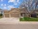 Charming two-story home with a stone facade, three-car garage, well-kept lawn, and welcoming front porch at 8766 Cresthill Ln, Highlands Ranch, CO 80130