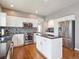 Well-lit kitchen with white cabinets, granite countertops, stainless steel appliances, and hardwood flooring at 8766 Cresthill Ln, Highlands Ranch, CO 80130