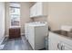 Well-lit laundry room equipped with a washer, dryer, utility sink, and storage cabinets at 8766 Cresthill Ln, Highlands Ranch, CO 80130