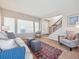Bright living room with a staircase, a large window, a decorative rug, and comfortable seating, perfect for relaxing and entertaining at 8766 Cresthill Ln, Highlands Ranch, CO 80130