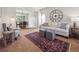 Cozy living room featuring a stylish rug, comfortable seating, and a view into the dining area, creating an inviting atmosphere at 8766 Cresthill Ln, Highlands Ranch, CO 80130