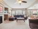 Inviting living room boasts a fireplace, large windows, and a comfortable sectional sofa, perfect for relaxing and entertaining at 8766 Cresthill Ln, Highlands Ranch, CO 80130