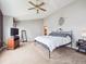 Spacious bedroom featuring a comfortable bed, ceiling fan, and ample natural light, providing a relaxing retreat at 8766 Cresthill Ln, Highlands Ranch, CO 80130