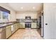 Well-lit kitchen with tile backsplash, stainless steel appliances, and tile floors at 9621 Elk Mountain Cir, Littleton, CO 80125