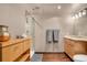 Modern bathroom with shower, double vanity, and wood floors at 1800 Lawrence St # 505, Denver, CO 80202