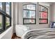 Bright bedroom with city view and comfy seating at 1800 Lawrence St # 505, Denver, CO 80202