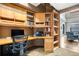 L-shaped home office with built-in cabinetry and a desk at 1800 Lawrence St # 505, Denver, CO 80202