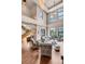 High-ceiling living room with hardwood floors and city views at 1800 Lawrence St # 505, Denver, CO 80202