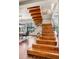 Modern floating staircase with glass railings and hardwood steps at 1800 Lawrence St # 505, Denver, CO 80202