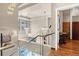 Modern glass staircase with chandelier and city views at 1800 Lawrence St # 505, Denver, CO 80202