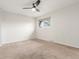 Neutral bedroom featuring large window and fan at 3667 W Union Ave # 2E, Denver, CO 80236