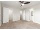 Spacious bedroom with neutral carpet, ceiling fan, and access to bathroom and closet space at 3667 W Union Ave # 2E, Denver, CO 80236