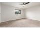 Spacious bedroom featuring neutral carpet, a window, and a ceiling fan at 3667 W Union Ave # 2E, Denver, CO 80236