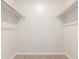 Empty walk-in closet with carpet flooring and rods to hang your clothes at 3667 W Union Ave # 2E, Denver, CO 80236
