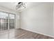 Neutral dining area featuring modern light fixture and sliding door access to the outside at 3667 W Union Ave # 2E, Denver, CO 80236