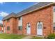 Brick townhomes with white trim, arched doorways, and manicured lawns at 3667 W Union Ave # 2E, Denver, CO 80236