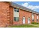 Charming brick townhomes with well-maintained landscaping, white doors, and visible unit numbers at 3667 W Union Ave # 2E, Denver, CO 80236