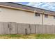 Rear exterior view of the building with beige siding and wooden fence at 3667 W Union Ave # 2E, Denver, CO 80236