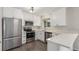 Modern kitchen features stainless steel appliances, white cabinets, and light countertops at 3667 W Union Ave # 2E, Denver, CO 80236