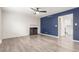 Inviting living room features a fireplace, contrasting wall, and wood-like flooring at 3667 W Union Ave # 2E, Denver, CO 80236