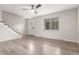 Spacious living room with new floors, neutral walls, and a modern ceiling fan at 3667 W Union Ave # 2E, Denver, CO 80236
