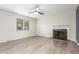 Bright living room with a fireplace, large window, and new wood-like flooring at 3667 W Union Ave # 2E, Denver, CO 80236