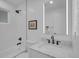 Bright bathroom with a modern vanity, shower over tub, and sleek, updated fixtures at 7126 Joan St, Denver, CO 80221