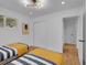 A well-lit bedroom boasts wood floors, stylish lighting, and coordinated decor creating a comfortable space at 7126 Joan St, Denver, CO 80221