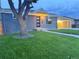 Charming single-story home with a well-manicured lawn, stylish carport, and modern front door at 7126 Joan St, Denver, CO 80221