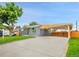 Attractive single-story home with a paved driveway, carport, manicured lawn, and modern front door at 7126 Joan St, Denver, CO 80221