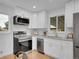 Bright kitchen featuring white cabinets, stainless steel appliances, and granite countertops at 7126 Joan St, Denver, CO 80221