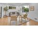 Inviting living room with comfortable seating, a large window, wood floors, and stylish decor at 7126 Joan St, Denver, CO 80221