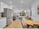Open floorplan with a living room, kitchen and dining area, featuring stainless appliances at 7126 Joan St, Denver, CO 80221