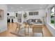 Bright, open-concept living room with modern furniture, hardwood floors, and updated kitchen in the background at 7126 Joan St, Denver, CO 80221