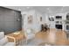 Stylish living area with modern wall paneling, wood floors, comfortable seating, and ample natural light at 7126 Joan St, Denver, CO 80221