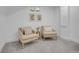 Inviting sitting area with two comfortable chairs and natural light from the above-ground windows at 7126 Joan St, Denver, CO 80221