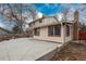 Back exterior of home featuring a concrete patio perfect for outdoor entertaining at 13778 W 71St Pl, Arvada, CO 80004