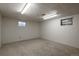 This basement area is carpeted and has recessed lighting and small windows at 13778 W 71St Pl, Arvada, CO 80004