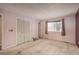 This bedroom features a window and a closet with bi-fold doors and wire shelving at 13778 W 71St Pl, Arvada, CO 80004