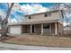 Traditional home featuring brick and vinyl siding, covered entry and attached garage at 13778 W 71St Pl, Arvada, CO 80004