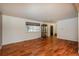 Cozy living room with hardwood floors, ample natural light, and front door access at 13778 W 71St Pl, Arvada, CO 80004