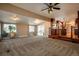 Open-concept living room showcases carpeted flooring and seamless flow into kitchen at 13778 W 71St Pl, Arvada, CO 80004