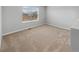 Cozy bedroom with plush carpeting and a bright window offering natural light at 2154 Alyssa St, Fort Lupton, CO 80621